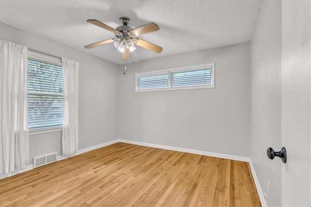 7934 Maple St, Prairie Village, KS 66208 - unfurnished room featuring plenty of natural light, light wood-type flooring, baseboards, a textured ceiling, and a ceiling fan