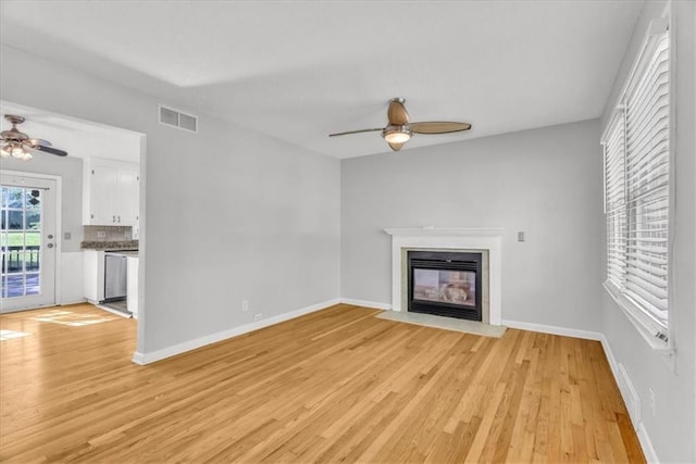 7934 Maple St, Prairie Village, KS 66208 - unfurnished living room with ceiling fan, light wood-style flooring, a fireplace with flush hearth, and baseboards