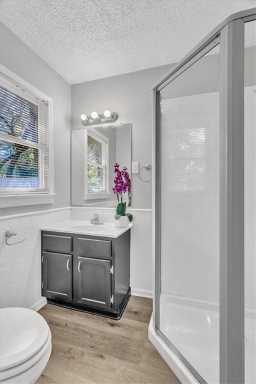 7934 Maple St, Prairie Village, KS 66208 - full bath featuring a textured ceiling, a shower stall, wood finished floors, vanity, and toilet