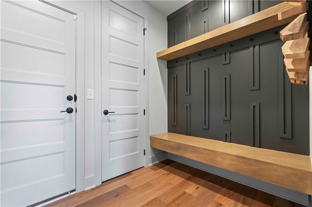 mudroom featuring light wood-type flooring and baseboards