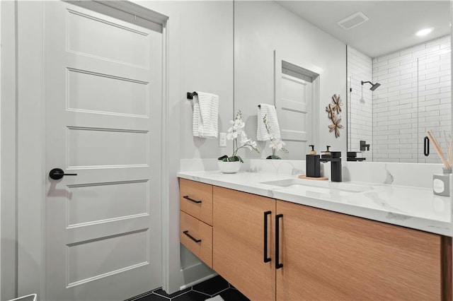 full bath featuring vanity, visible vents, and a stall shower