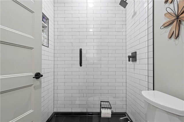 full bath with a stall shower and toilet