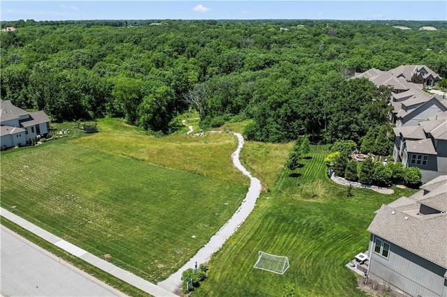 drone / aerial view featuring a residential view and a forest view
