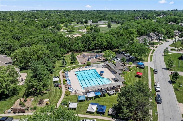 birds eye view of property featuring a wooded view