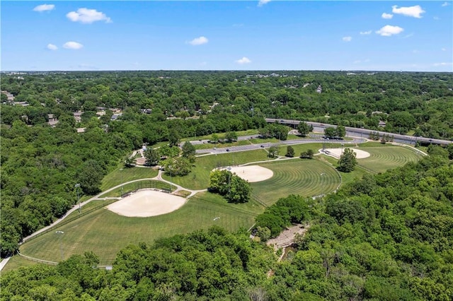 birds eye view of property featuring a view of trees