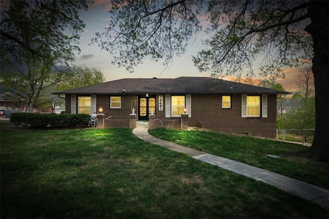 10401 Cypress Dr, Kansas City, MO 64137 - ranch-style house featuring fence, brick siding, and a front yard