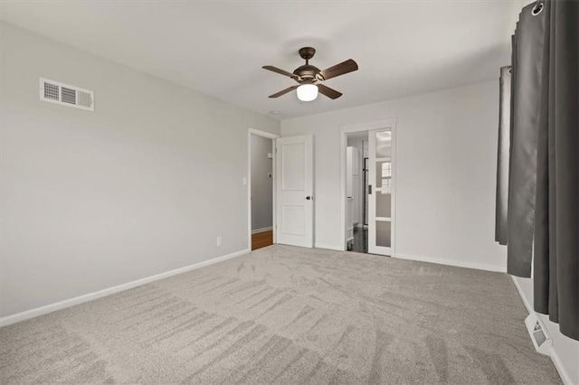 10401 Cypress Dr, Kansas City, MO 64137 - unfurnished bedroom with visible vents, carpet flooring, baseboards, and ceiling fan