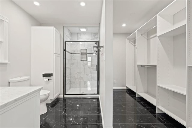 10401 Cypress Dr, Kansas City, MO 64137 - bathroom with a stall shower, granite finish floor, baseboards, toilet, and recessed lighting