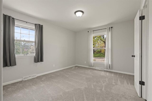 10401 Cypress Dr, Kansas City, MO 64137 - carpeted spare room featuring baseboards and visible vents
