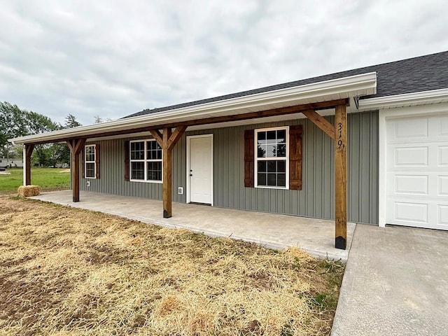 property entrance with board and batten siding and a garage