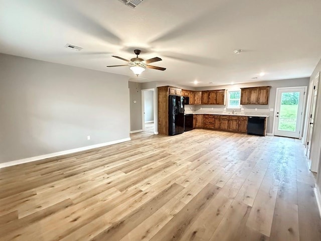 kitchen with light countertops, open floor plan, baseboards, visible vents, and black appliances
