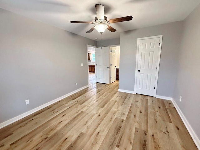 unfurnished bedroom with light wood-style floors, baseboards, and a ceiling fan