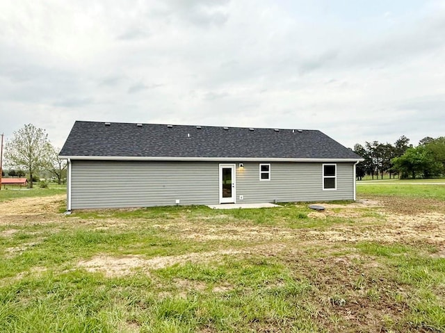 rear view of property with a lawn