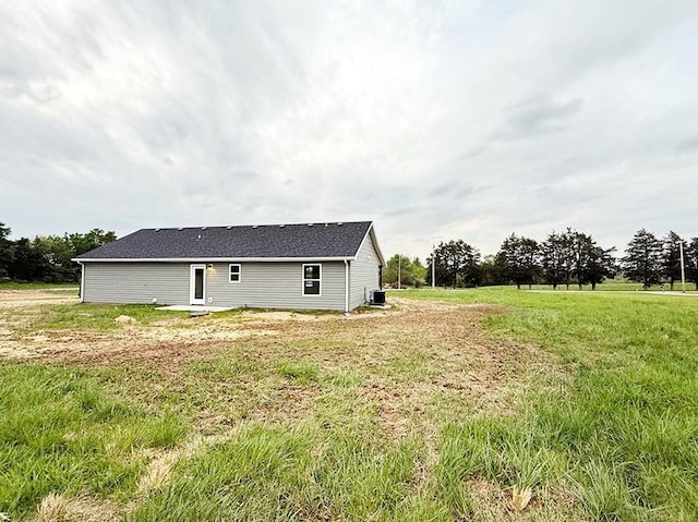 exterior space featuring central AC and a yard