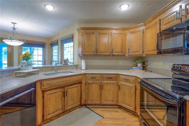 14241 W 113th Ter, Olathe, KS 66062 - kitchen with black appliances, a sink, a textured ceiling, backsplash, and light countertops