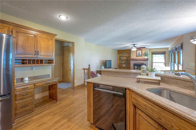 14241 W 113th Ter, Olathe, KS 66062 - kitchen with black dishwasher, freestanding refrigerator, a sink, brown cabinets, and light wood finished floors
