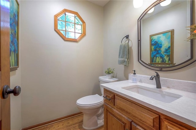 14241 W 113th Ter, Olathe, KS 66062 - half bathroom featuring toilet, vanity, and wood finished floors