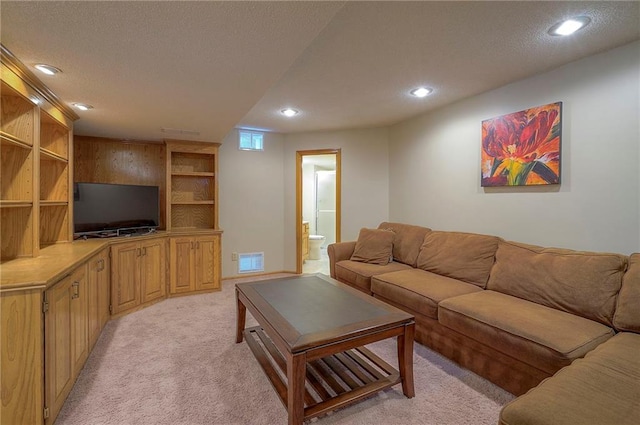 14241 W 113th Ter, Olathe, KS 66062 - living room with light carpet, recessed lighting, and a textured ceiling