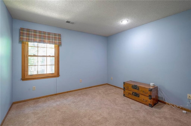 14241 W 113th Ter, Olathe, KS 66062 - spare room featuring carpet flooring, a textured ceiling, and baseboards