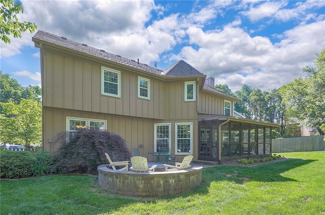 14241 W 113th Ter, Olathe, KS 66062 - back of house with a sunroom, a fire pit, and board and batten siding