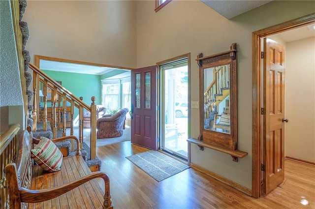 14241 W 113th Ter, Olathe, KS 66062 - foyer entrance featuring stairway, wood finished floors, baseboards, and a high ceiling