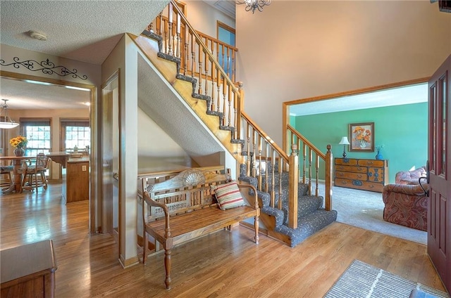 14241 W 113th Ter, Olathe, KS 66062 - stairs featuring wood finished floors and a chandelier
