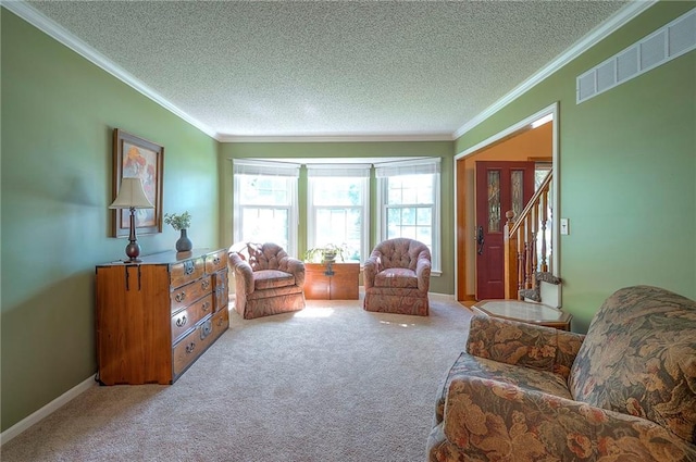 14241 W 113th Ter, Olathe, KS 66062 - carpeted living room with ornamental molding, a textured ceiling, stairway, and baseboards
