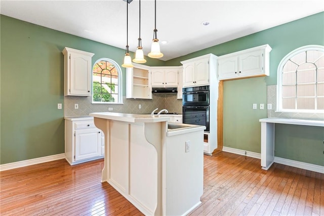 21710 W 61st St, Shawnee, KS 66218 - kitchen with light wood finished floors, white cabinetry, pendant lighting, tasteful backsplash, and recessed lighting