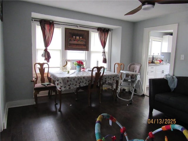 dining room with dark wood-style flooring and a ceiling fan