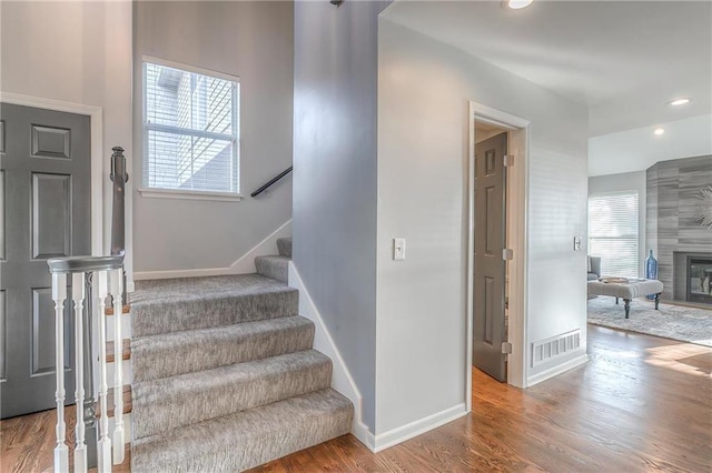 4016 W 79th St, Prairie Village, KS 66208 - staircase featuring visible vents, a fireplace, wood finished floors, baseboards, and recessed lighting