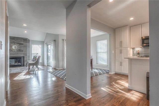 4016 W 79th St, Prairie Village, KS 66208 - kitchen featuring baseboards, stainless steel microwave, dark wood finished floors, and white cabinetry