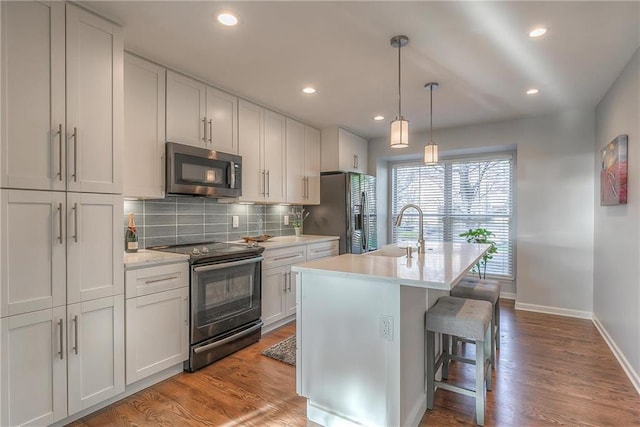 4016 W 79th St, Prairie Village, KS 66208 - kitchen with a sink, light countertops, stainless steel appliances, baseboards, and decorative backsplash