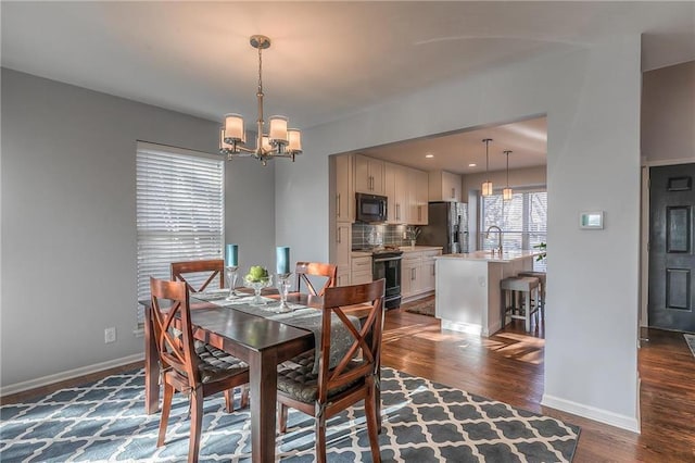 4016 W 79th St, Prairie Village, KS 66208 - dining space featuring baseboards, dark wood finished floors, and a notable chandelier