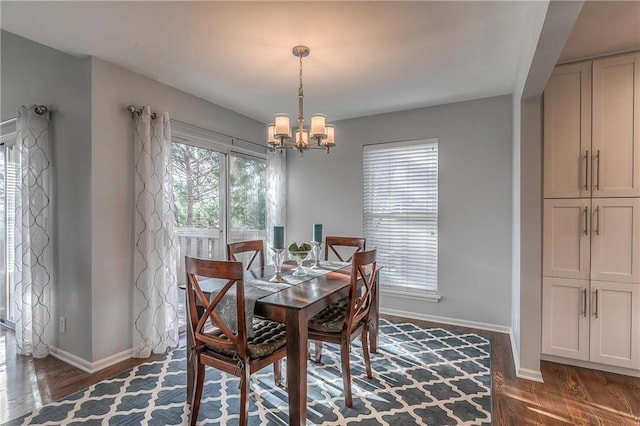 4016 W 79th St, Prairie Village, KS 66208 - dining area with baseboards, wood finished floors, and an inviting chandelier