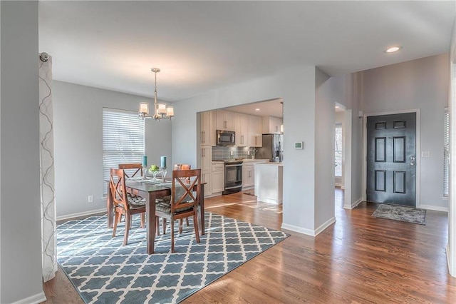 4016 W 79th St, Prairie Village, KS 66208 - dining space with baseboards, wood finished floors, and a chandelier
