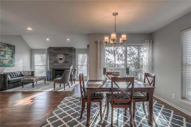 4016 W 79th St, Prairie Village, KS 66208 - dining space featuring a healthy amount of sunlight, a large fireplace, wood finished floors, and a notable chandelier