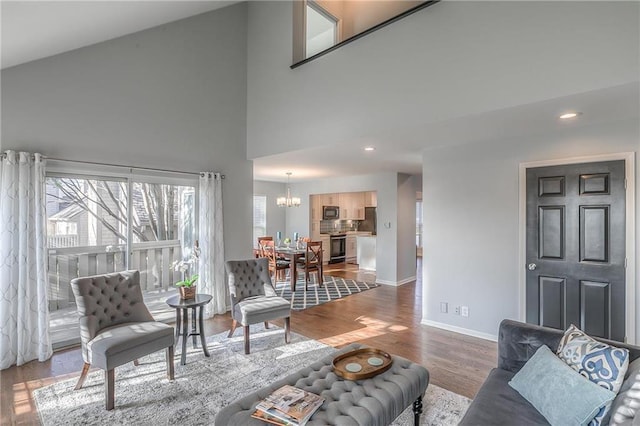 4016 W 79th St, Prairie Village, KS 66208 - living room with a high ceiling, a chandelier, recessed lighting, baseboards, and wood finished floors