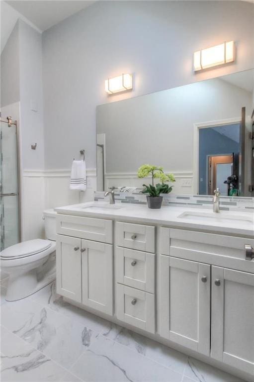 4016 W 79th St, Prairie Village, KS 66208 - full bathroom with wainscoting, a sink, double vanity, marble finish floor, and a shower stall