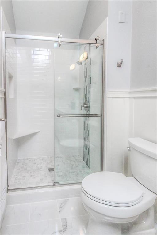 4016 W 79th St, Prairie Village, KS 66208 - bathroom with a shower stall, a wainscoted wall, toilet, marble finish floor, and a decorative wall