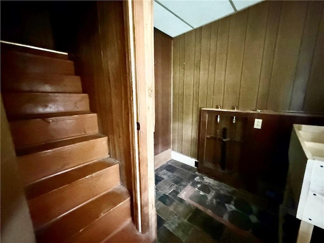 stairs featuring wooden walls