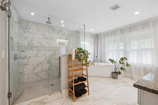 3804 Harrison St, Kansas City, MO 64109 - bathroom featuring visible vents, marble finish floor, a freestanding tub, recessed lighting, and a stall shower