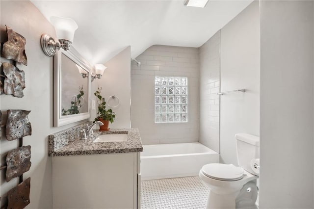3804 Harrison St, Kansas City, MO 64109 - full bath with vaulted ceiling, bathtub / shower combination, vanity, tile patterned floors, and toilet