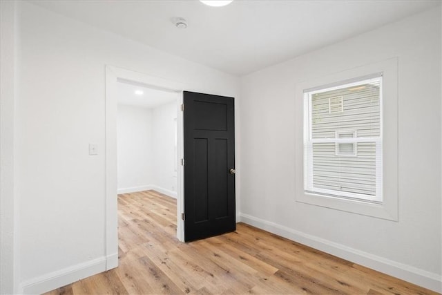 15015 E Truman Rd, Independence, MO 64050 - spare room with baseboards and light wood-style floors