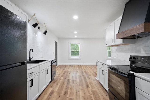 15015 E Truman Rd, Independence, MO 64050 - kitchen featuring a sink, light countertops, decorative backsplash, custom range hood, and black appliances