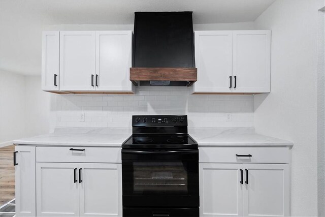 15015 E Truman Rd, Independence, MO 64050 - kitchen featuring white cabinetry, backsplash, custom exhaust hood, and black range with electric stovetop