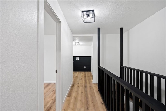 15015 E Truman Rd, Independence, MO 64050 - corridor with a textured ceiling, a textured wall, and light wood-type flooring
