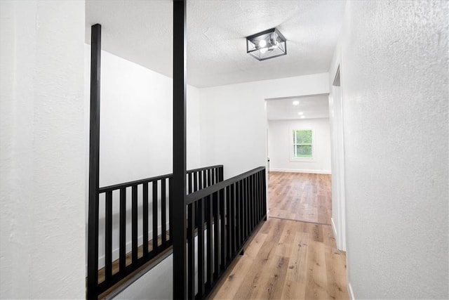 15015 E Truman Rd, Independence, MO 64050 - hall featuring a textured ceiling, a textured wall, and light wood-type flooring
