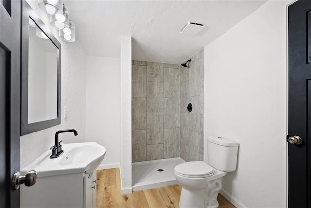 15015 E Truman Rd, Independence, MO 64050 - full bath with toilet, a stall shower, wood finished floors, and vanity