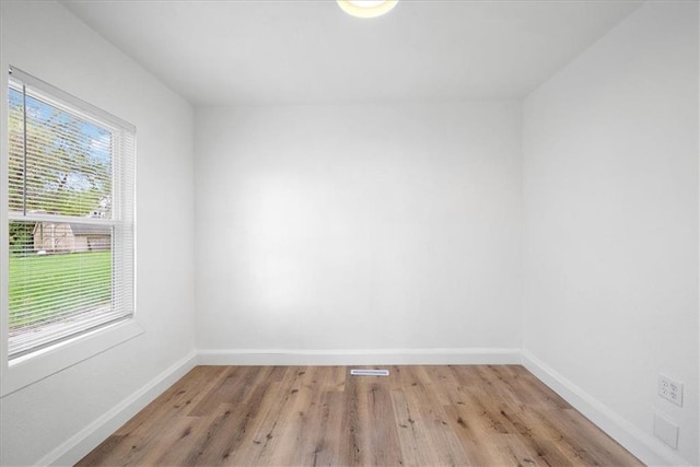 15015 E Truman Rd, Independence, MO 64050 - spare room featuring baseboards and wood finished floors