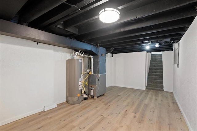 15015 E Truman Rd, Independence, MO 64050 - finished below grade area with heating unit, wood finished floors, stairway, and gas water heater